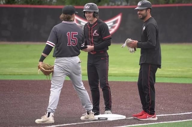 Cole Canlon stands on first smiling after a base hot. 